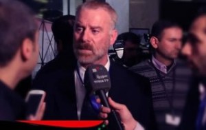 Mike Harris, host of the radio show “The Short End of the Stick,” on the Freedom Slips radio network, is interviewed by Syrian TV