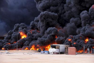 Smoke rises from burning oil storage tanks in the port of Ras Lanuf. (Reuters photo) Smoke rises from burning oil storage tanks in the port of Ras Lanuf. (Reuters photo)